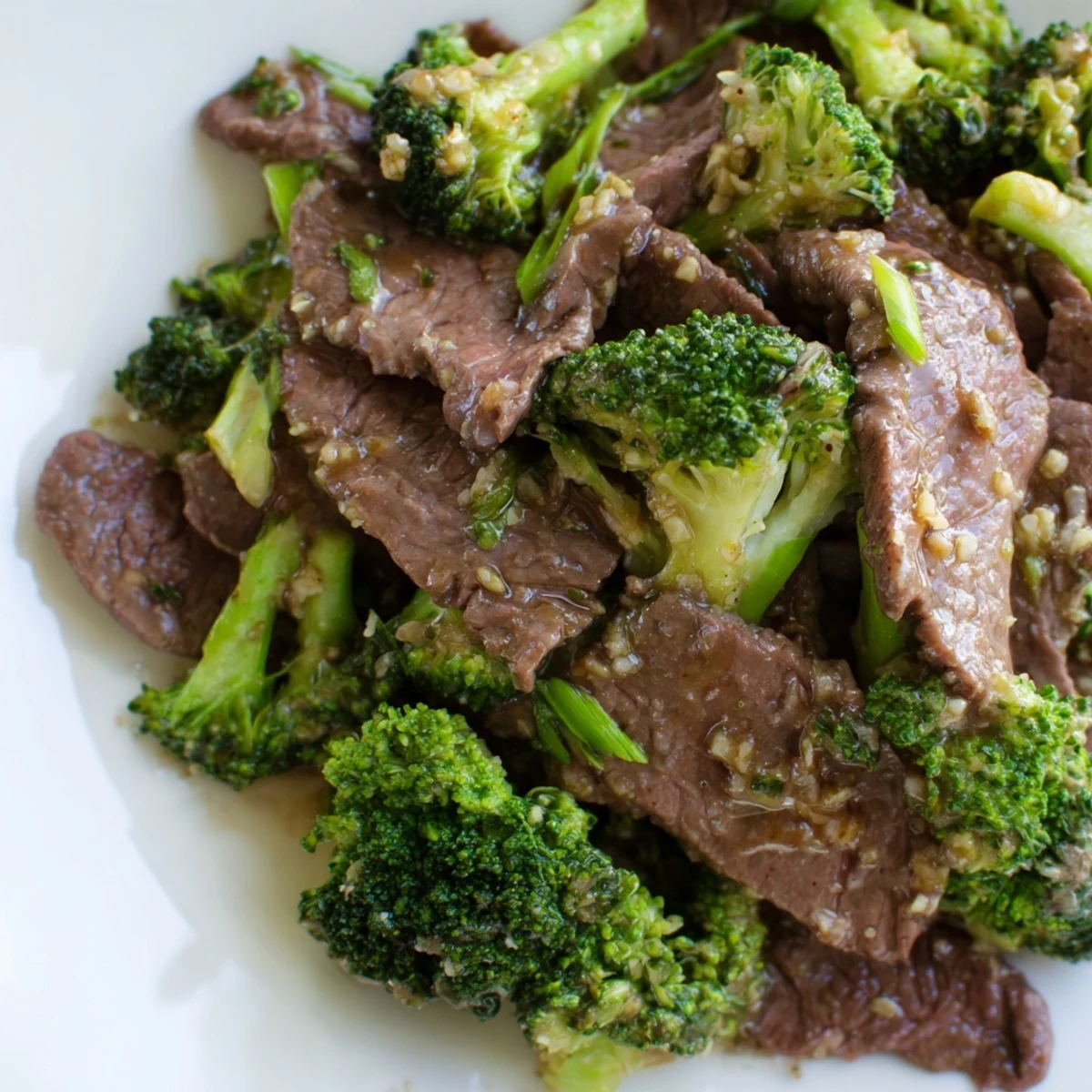 Close-up of Keto Friendly Beef and Broccoli Stir Fry highlighting glossy sauce, crisp broccoli florets, and juicy slices of flank steak.