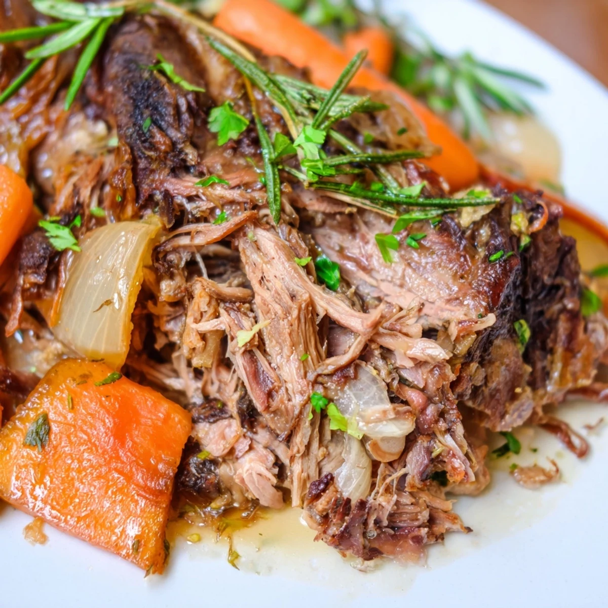 Succulent Slow Cooked Lamb Shoulder served over creamy mashed potatoes with fresh parsley garnish.