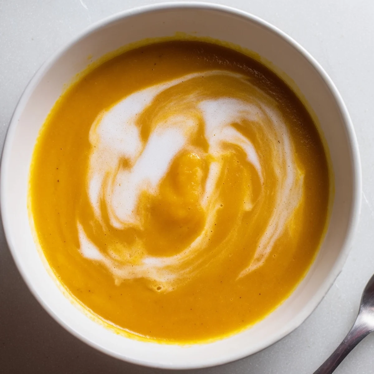 Golden, caramelized cubes of roasted butternut squash and apple soup simmering in a pot.