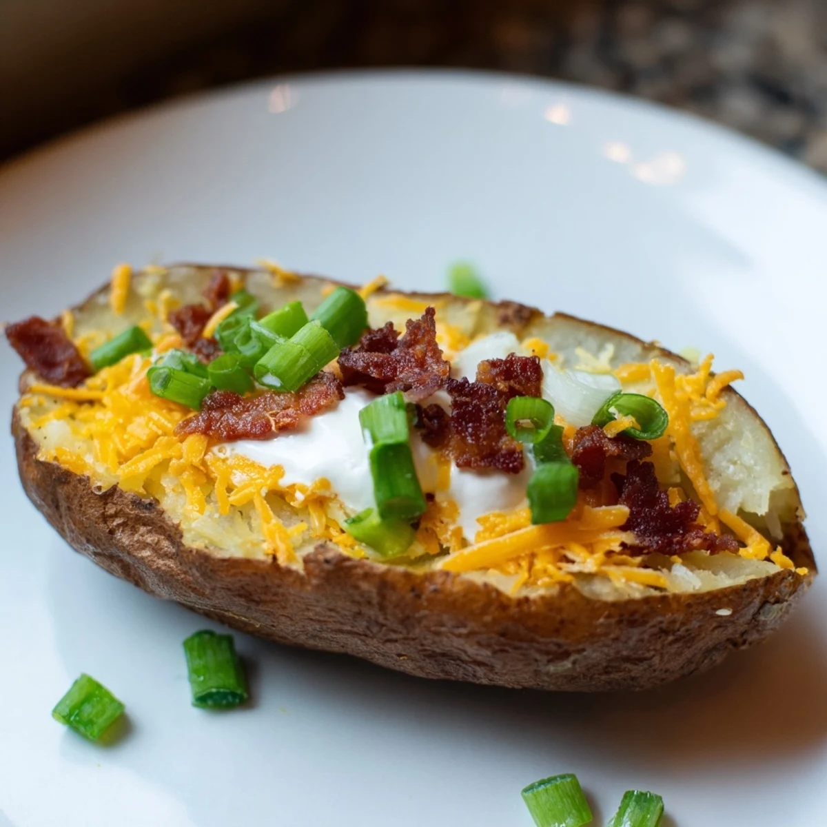 Fresh green onions garnish these bubbly, cheese-topped Game Day Loaded Potato Skins with Beef Bacon.