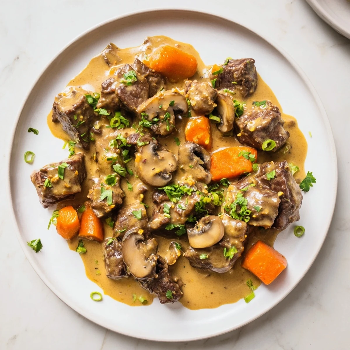 A close-up of Lemongrass Coconut Braised Beef with Mushrooms, garnished with fresh cilantro and scallions on jasmine rice.