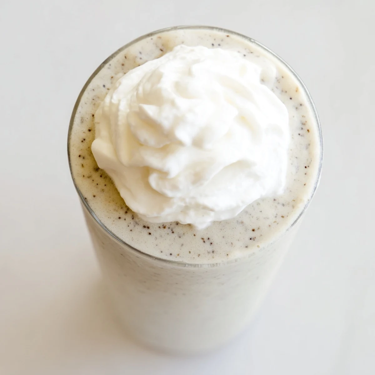 Refreshing Vanilla Bean Frappuccino poured into a frosty glass, ready to sip on a warm day.