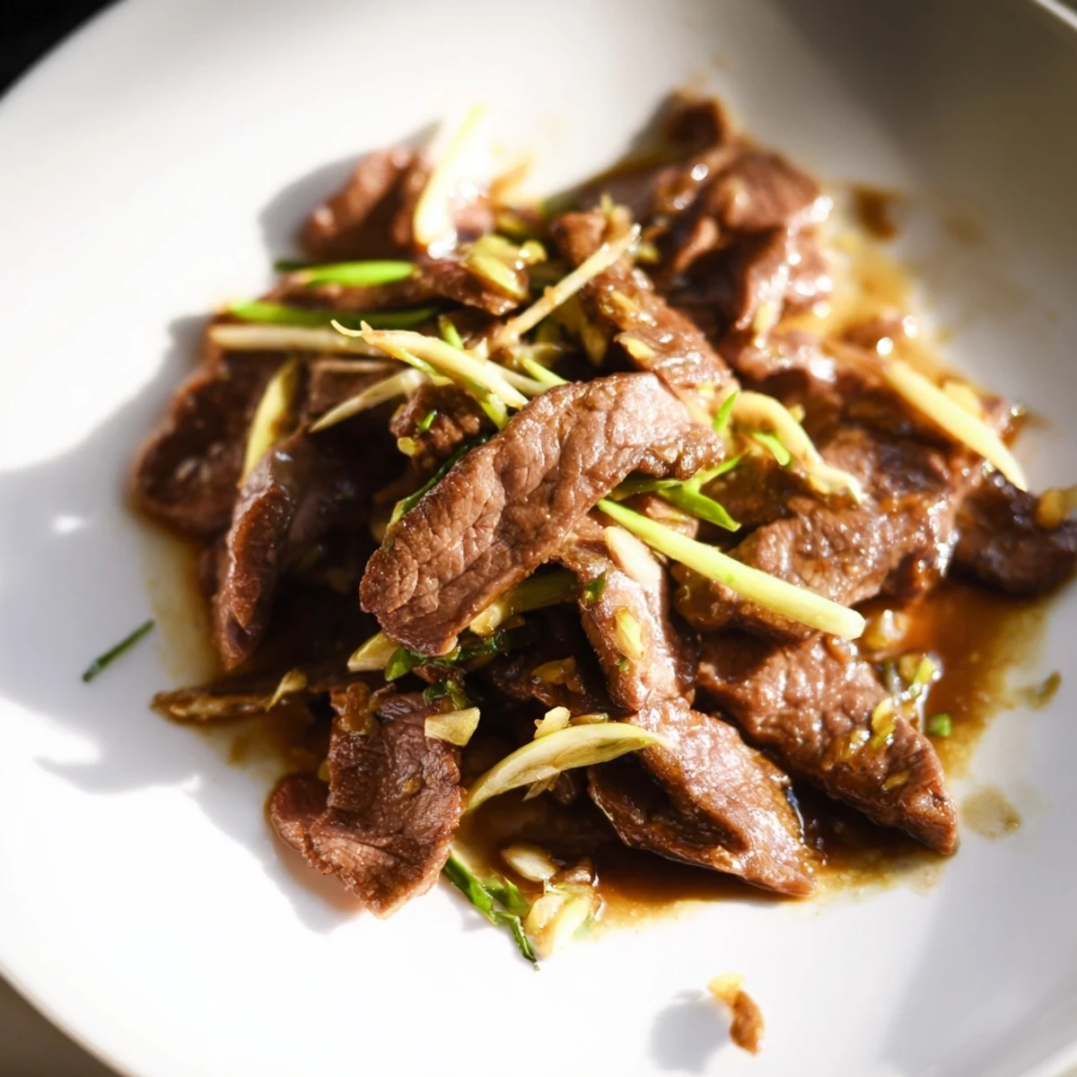 Beef With Oyster Sauce plated in a white bowl, garnished with sesame seeds and ready for a quick weeknight dinner.