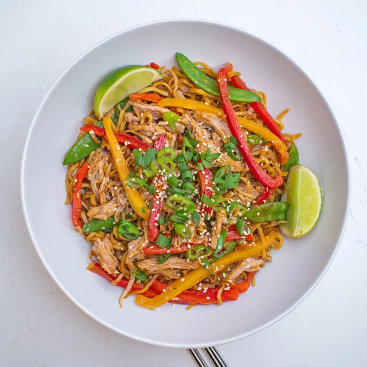 This Sweet Chilli Turkey Noodle Stir Fry shows crispy vegetables and silky noodles tossed in a glossy red sauce.