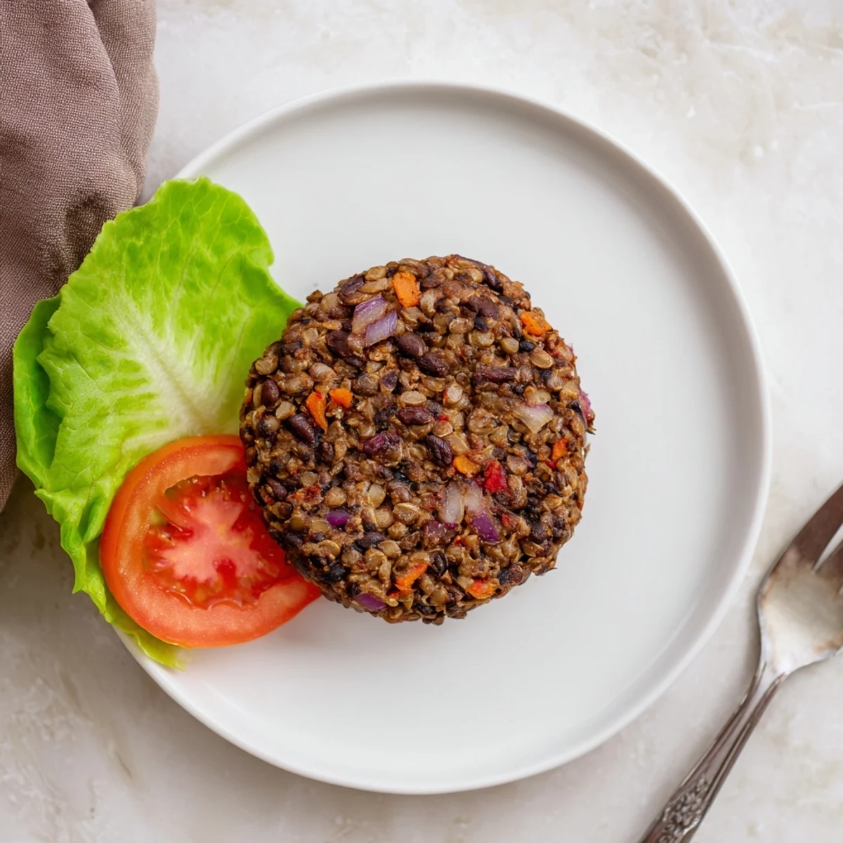 Homemade mushroom veggie burgers garnished with fresh parsley and arranged with colorful veggies for a vibrant meal.