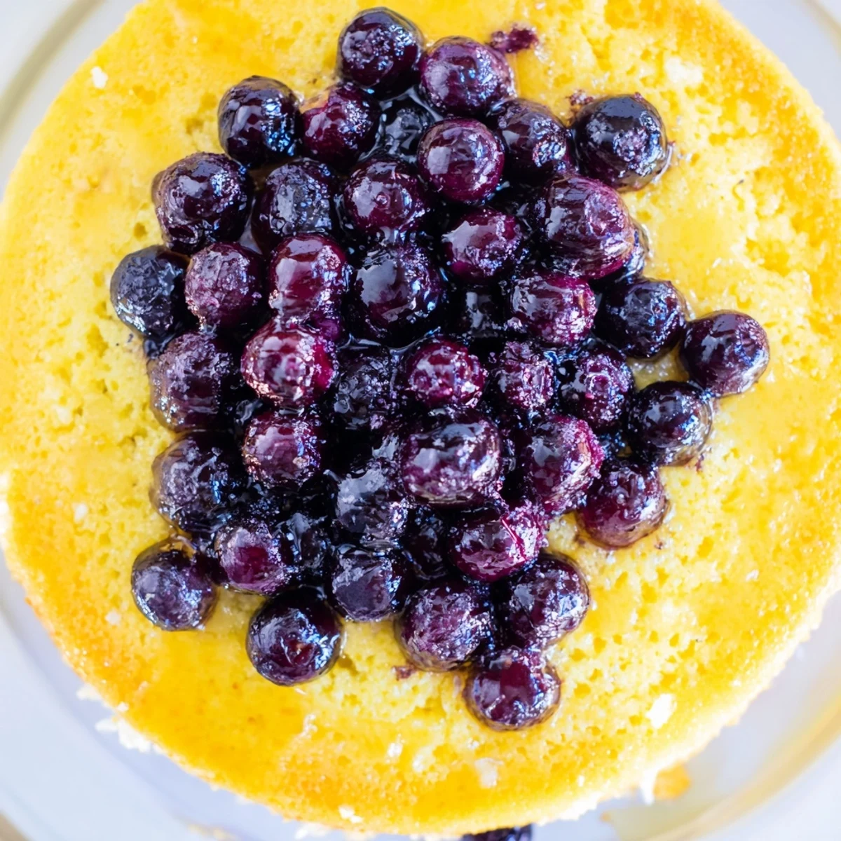 Moist blueberry upside down cake with juicy fruit layer revealed after flipping onto serving platter
