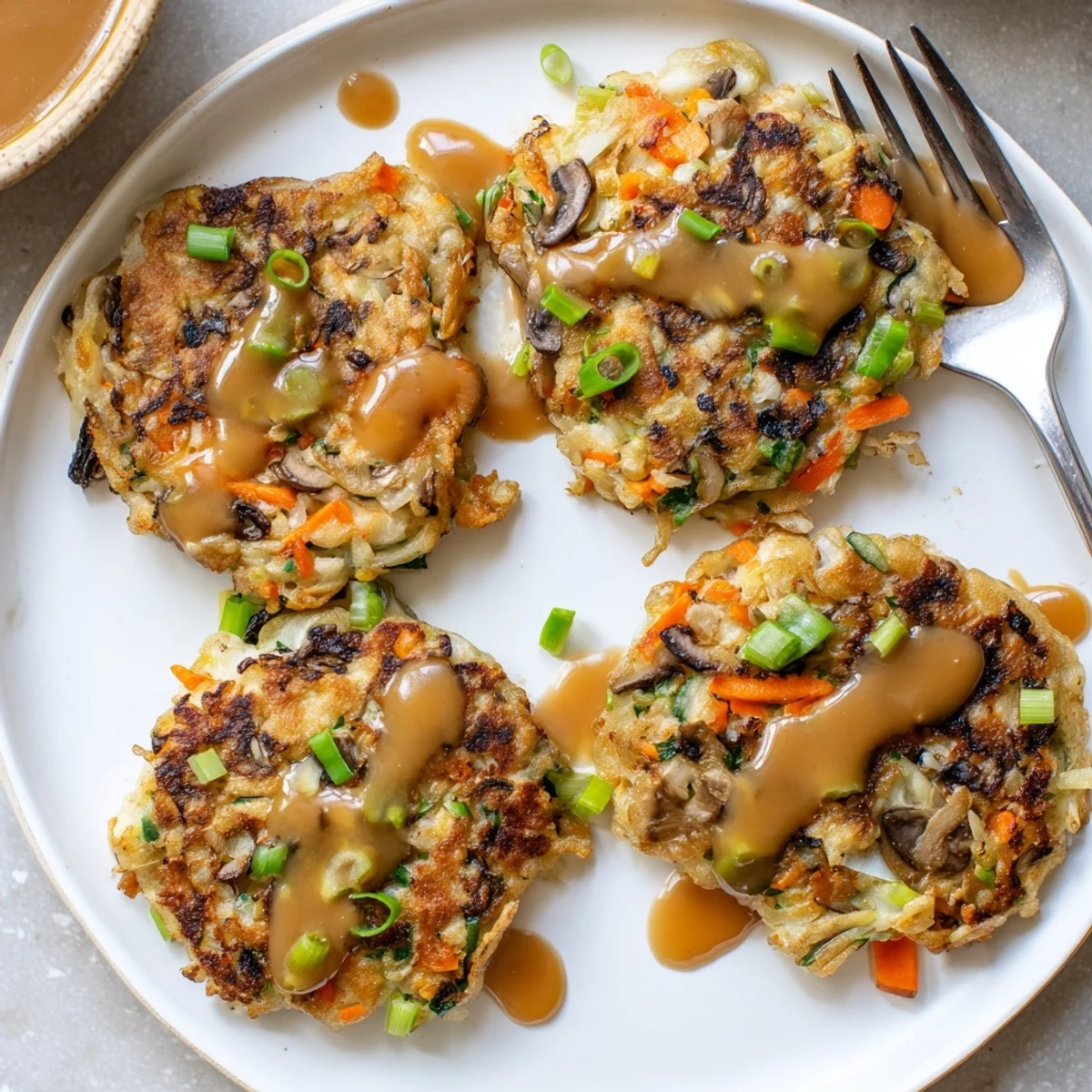 Golden crispy Egg Foo Young patties topped with rich savory brown gravy