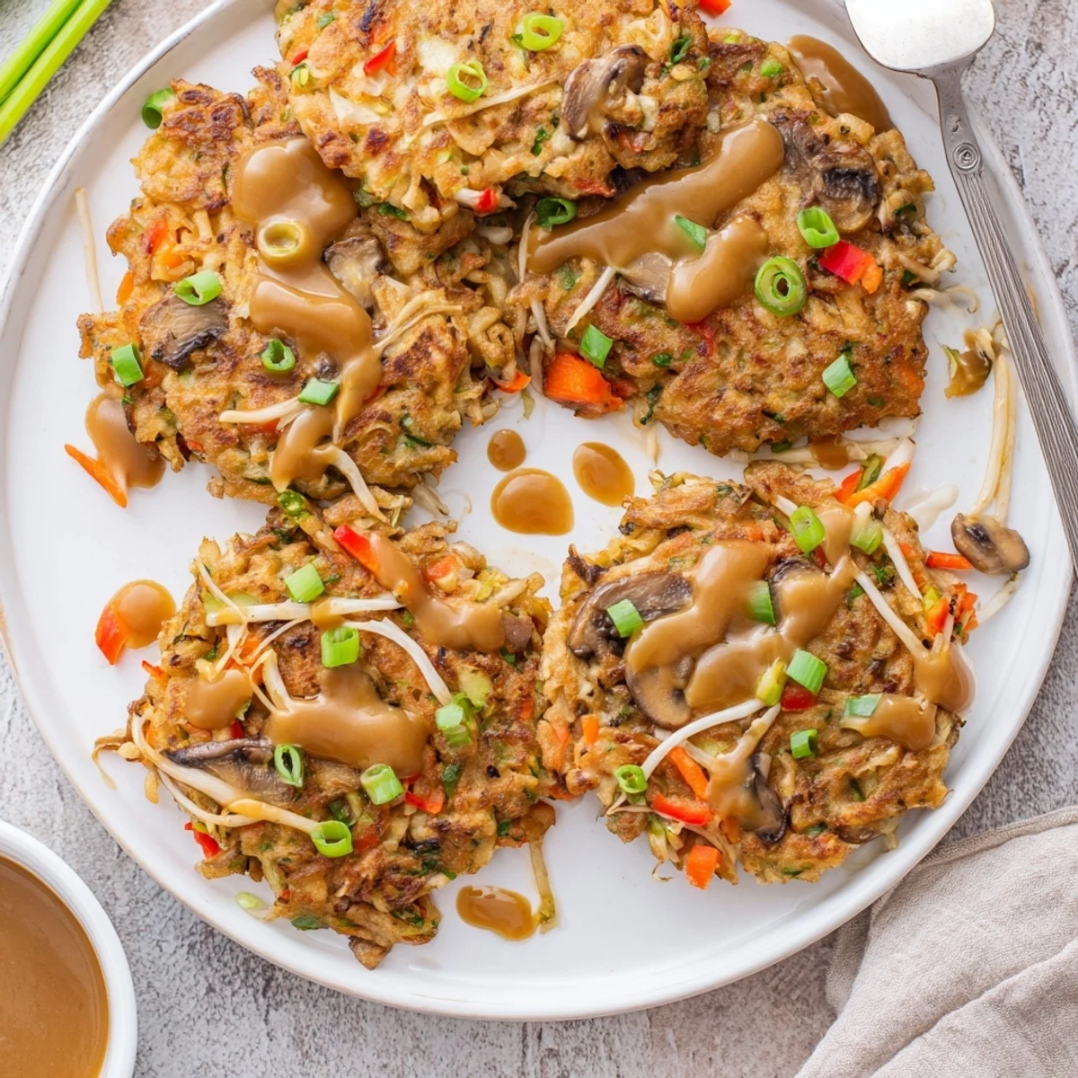 Fluffy vegetable-packed Egg Foo Young omelet fried to golden perfection