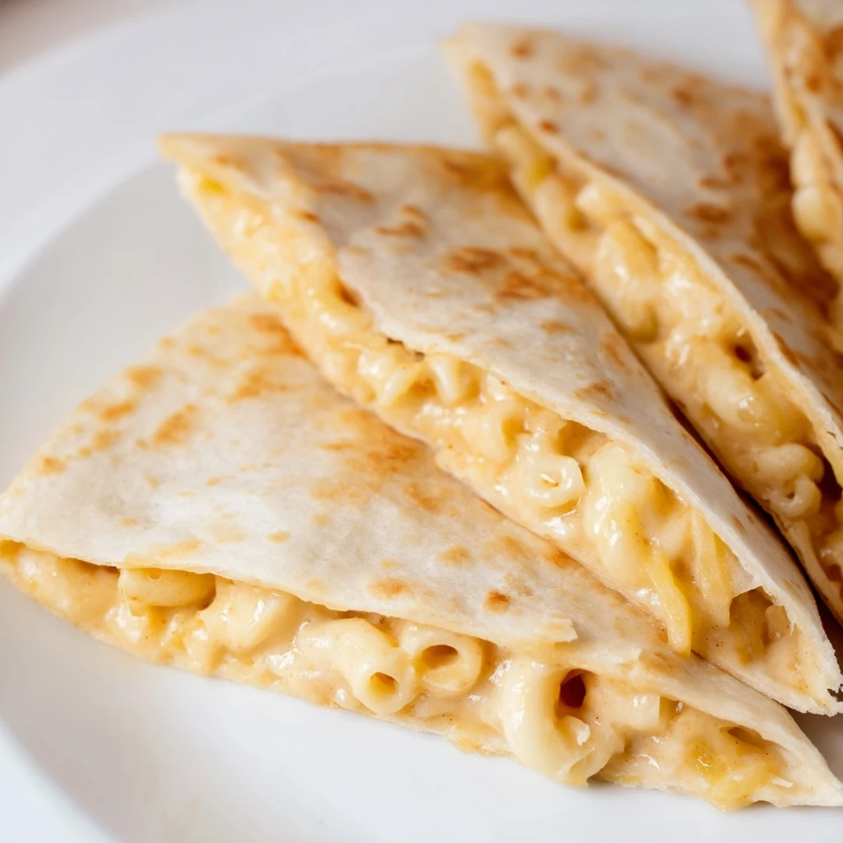 Crispy tortilla stuffed with homemade macaroni and cheese oozing melted cheddar and Monterey Jack