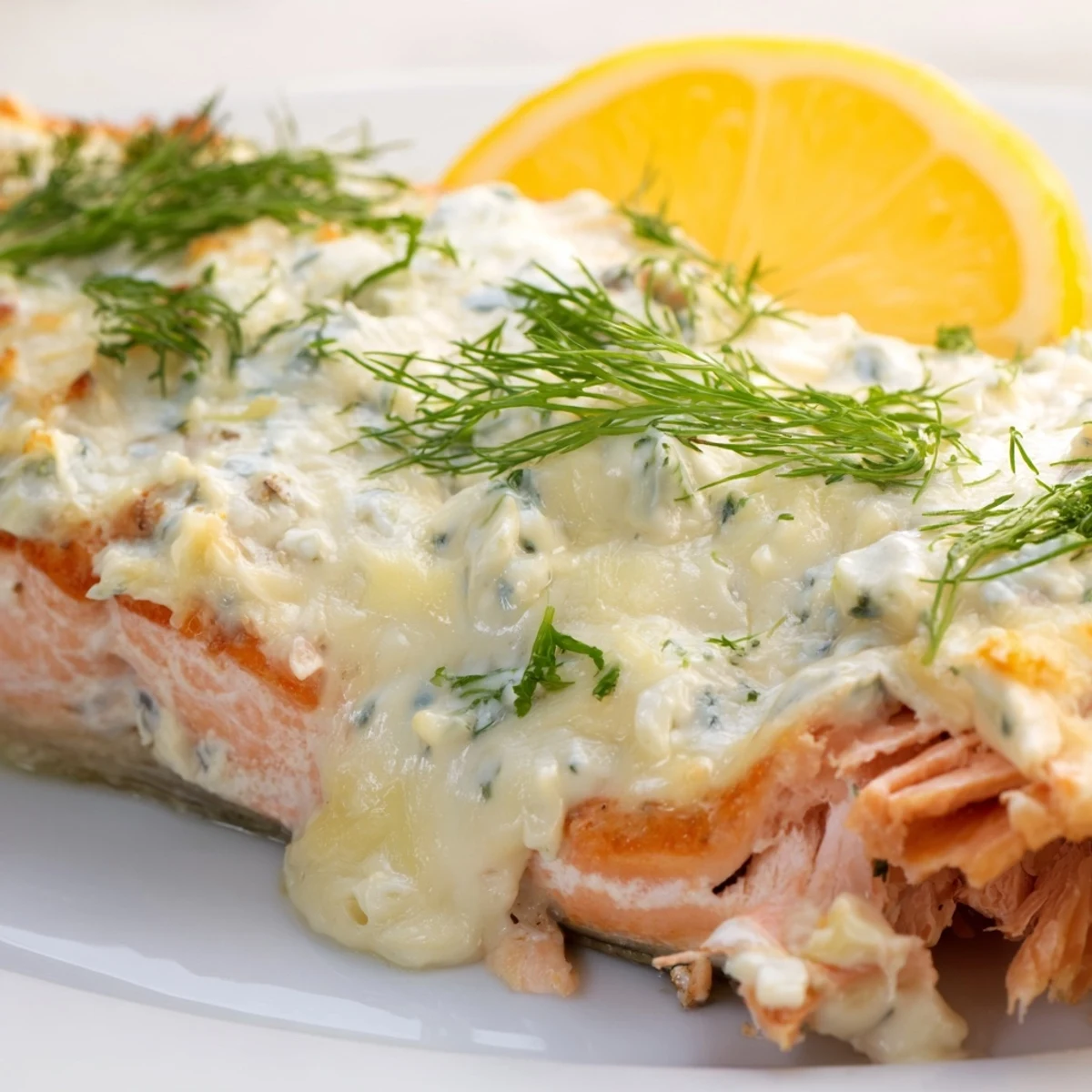 Oven-baked salmon with rich Boursin cheese crust, lemon rounds, and dill sprinkles