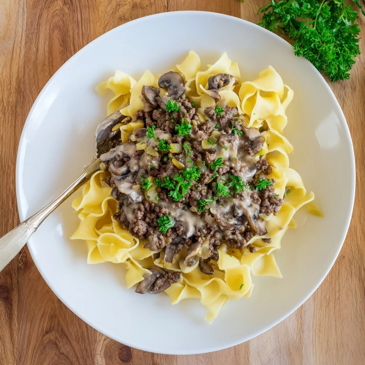 Comforting hamburger stroganoff plated with savory beef, sliced mushrooms, and fluffy egg noodles