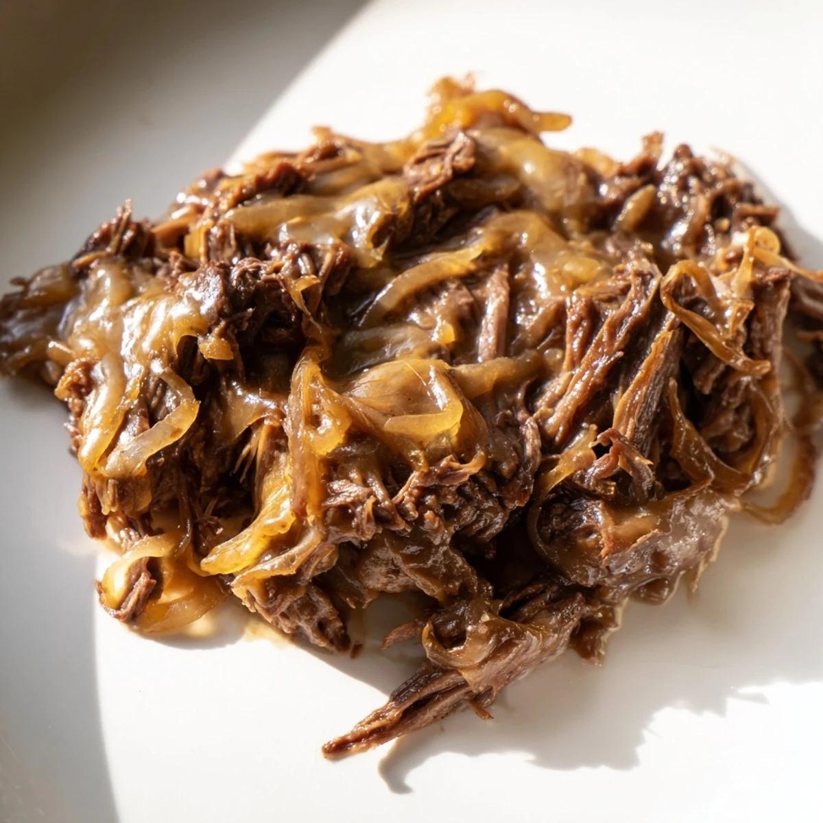 Succulent beef chuck roast braised with baby potatoes and carrots in a rich, savory onion gravy