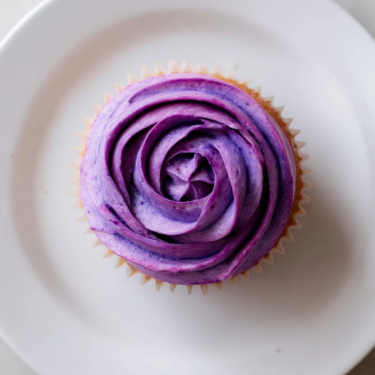 Batch of twelve vibrant grape soda cupcakes arranged for a birthday party dessert display