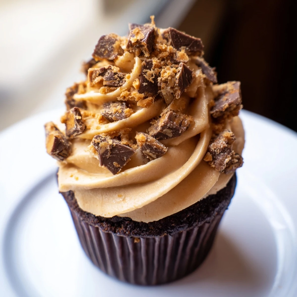 Rich chocolate cupcakes filled with creamy peanut butter and sprinkled with Butterfinger crumbs