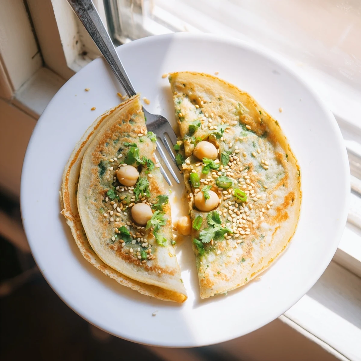 Golden Mont Lin Ma Yar pancakes paired together with quail eggs and fresh green cilantro garnish