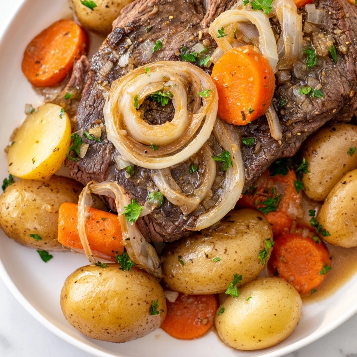Comforting slow cooker steak and potatoes featuring fork-tender beef steaks and caramelized onion slices