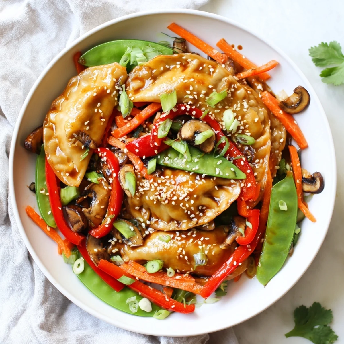 Steamy wok full of potsticker stir fry with fresh vegetables coated in glossy hoisin glaze