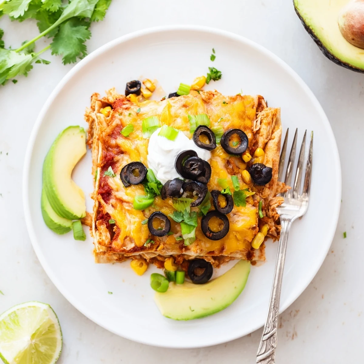 Cheesy Shredded Chicken Enchilada Bake with bubbling golden cheese and vibrant fresh cilantro garnish