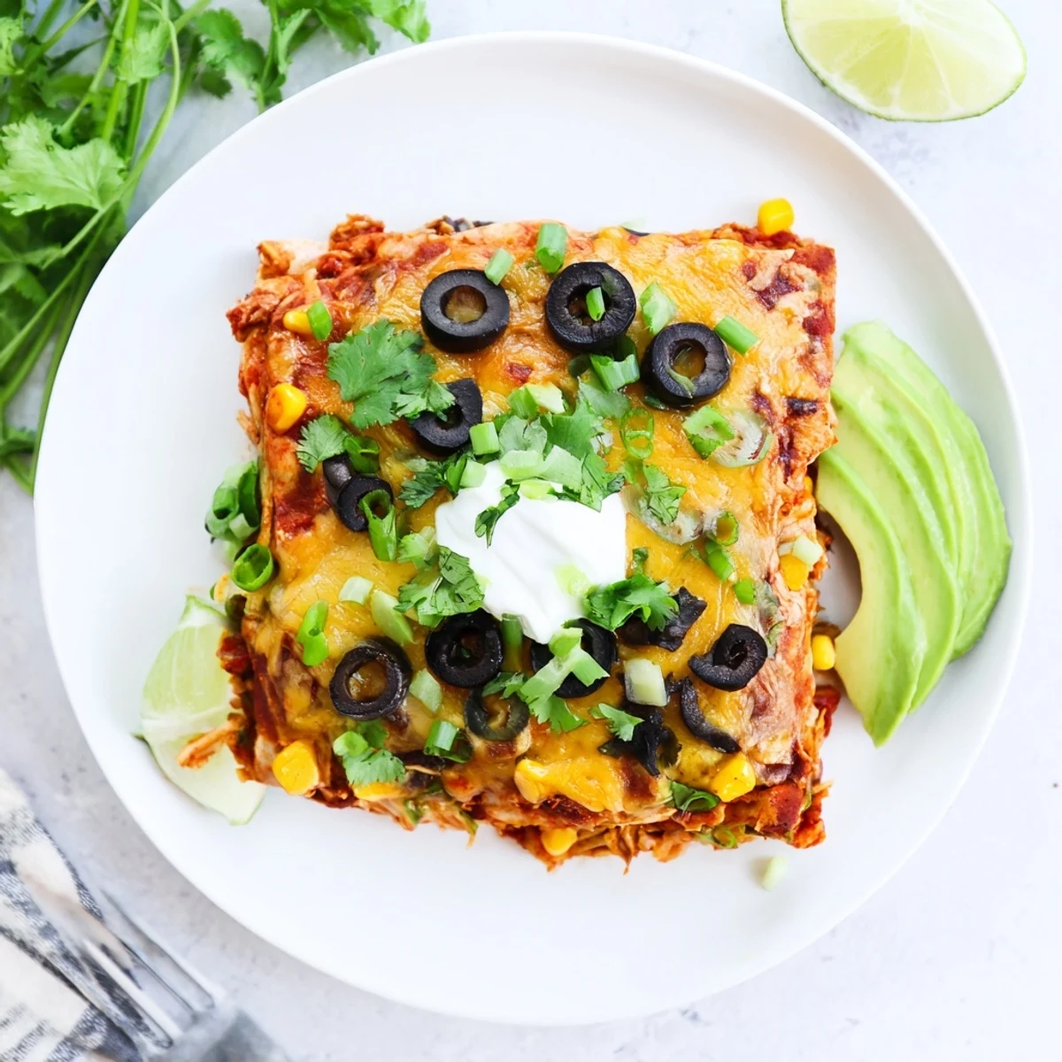 Golden melted cheese tops this Cheesy Shredded Chicken Enchilada Bake casserole with black beans and corn