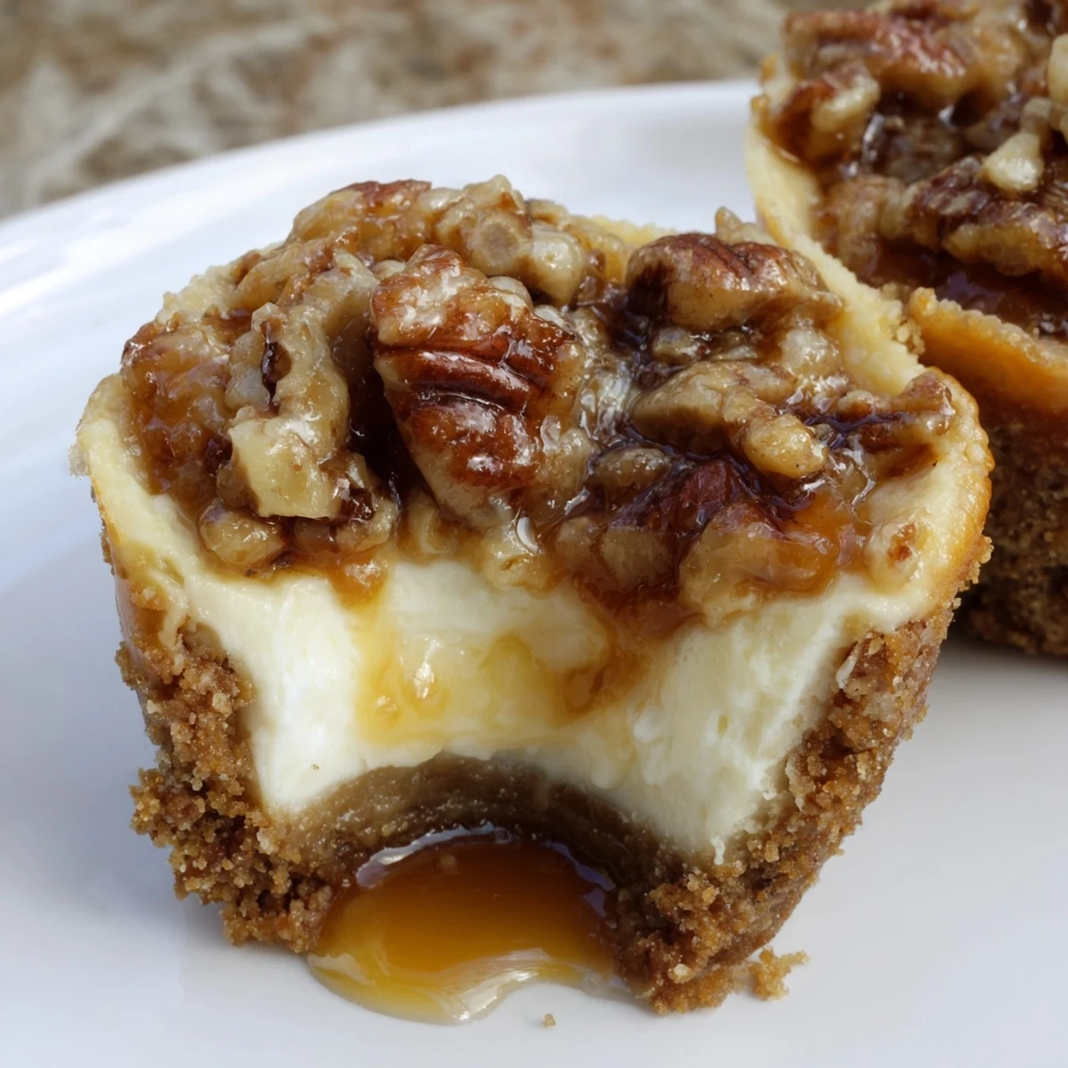 Mini Pecan Pie Cheesecakes arranged on a white platter, ready for Thanksgiving guests