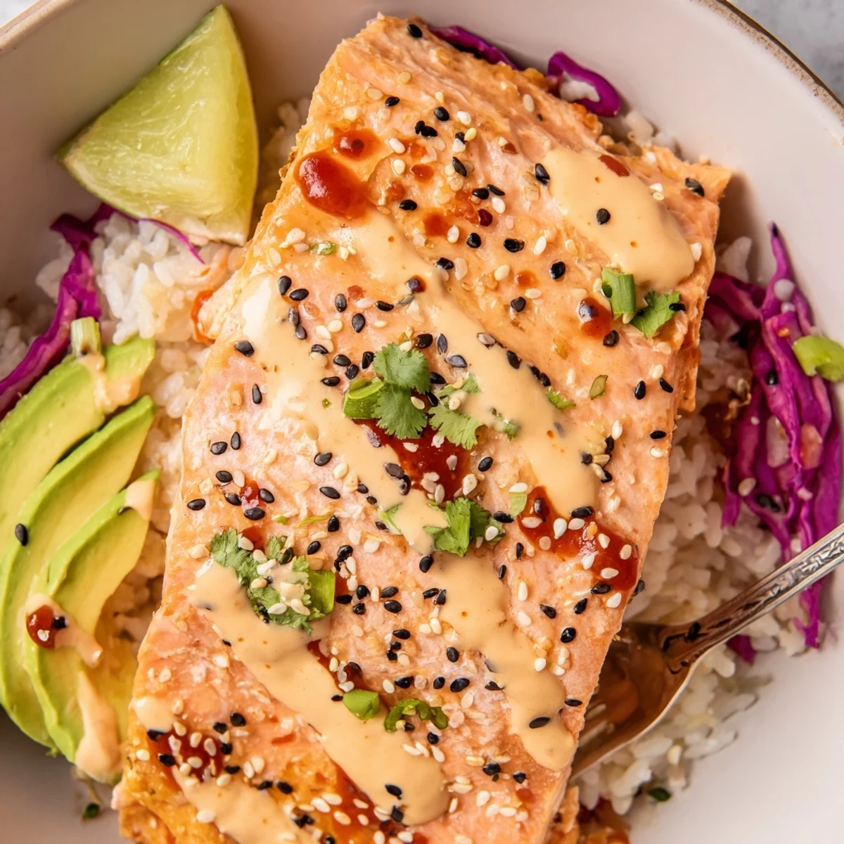 Bang Bang Salmon Bowls with roasted salmon, creamy spicy sauce, avocado slices