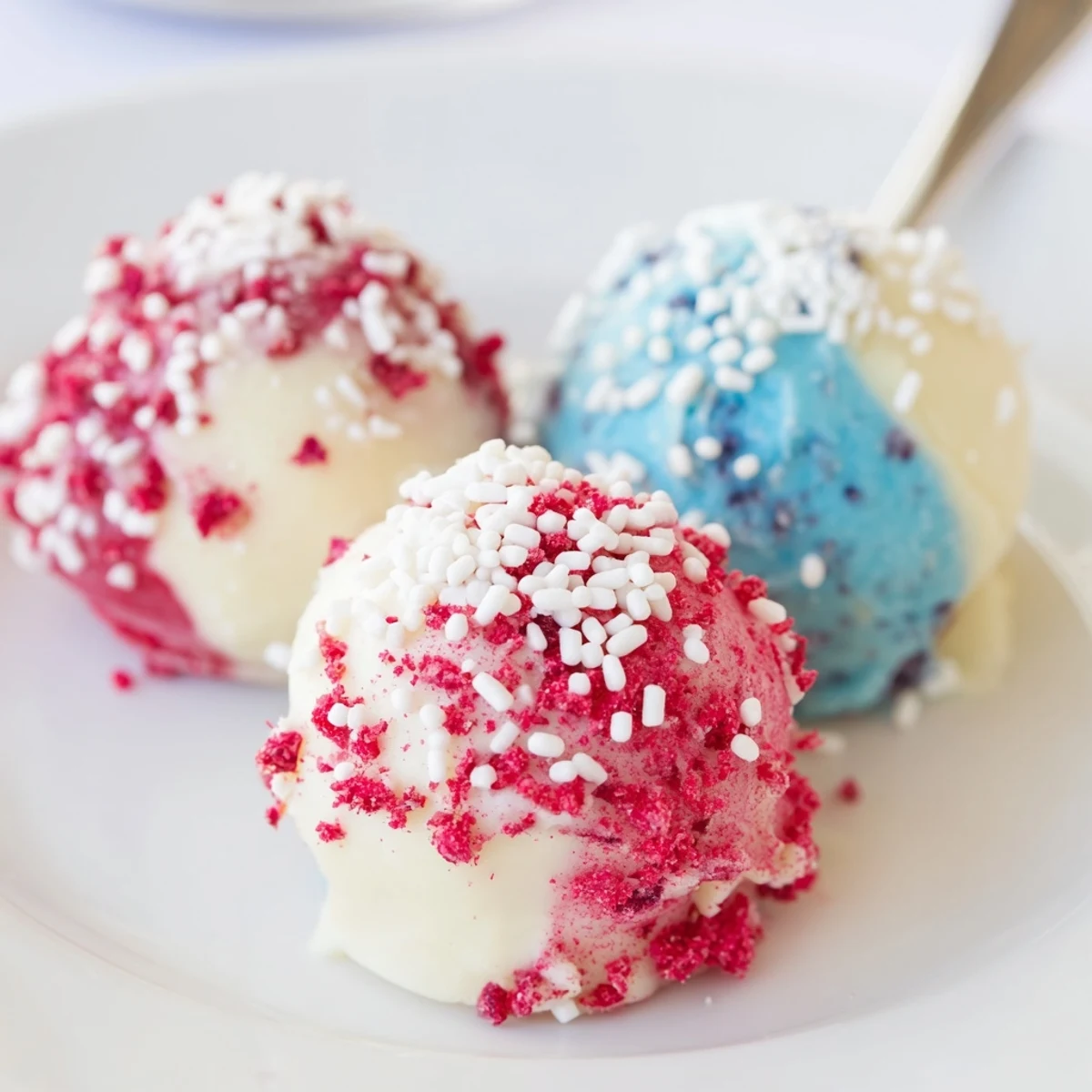 Creamy July truffles in red, white, and blue, chilled on plate