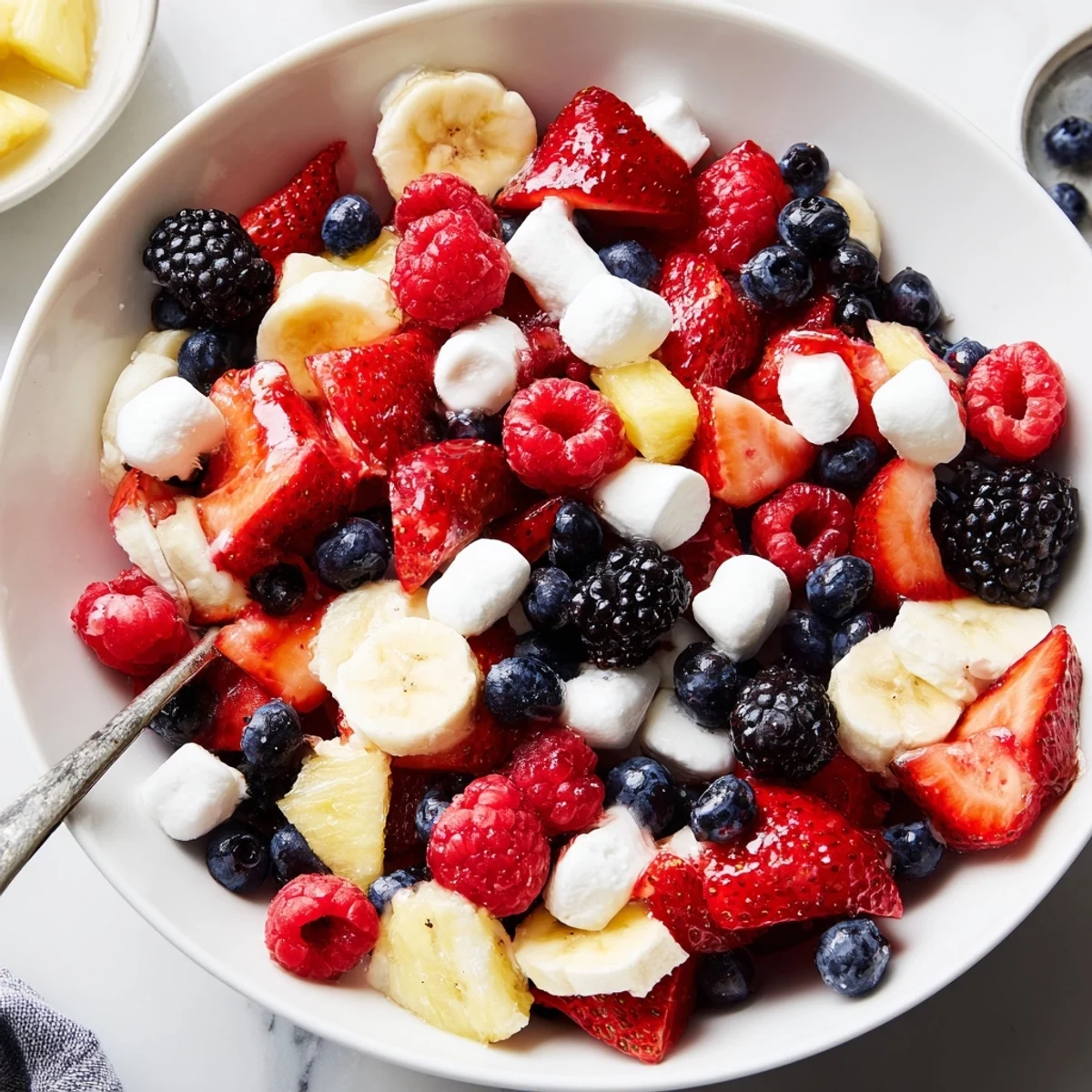 Red White And Blue Fruit Salad with juicy berries, pineapple, and lime drizzle