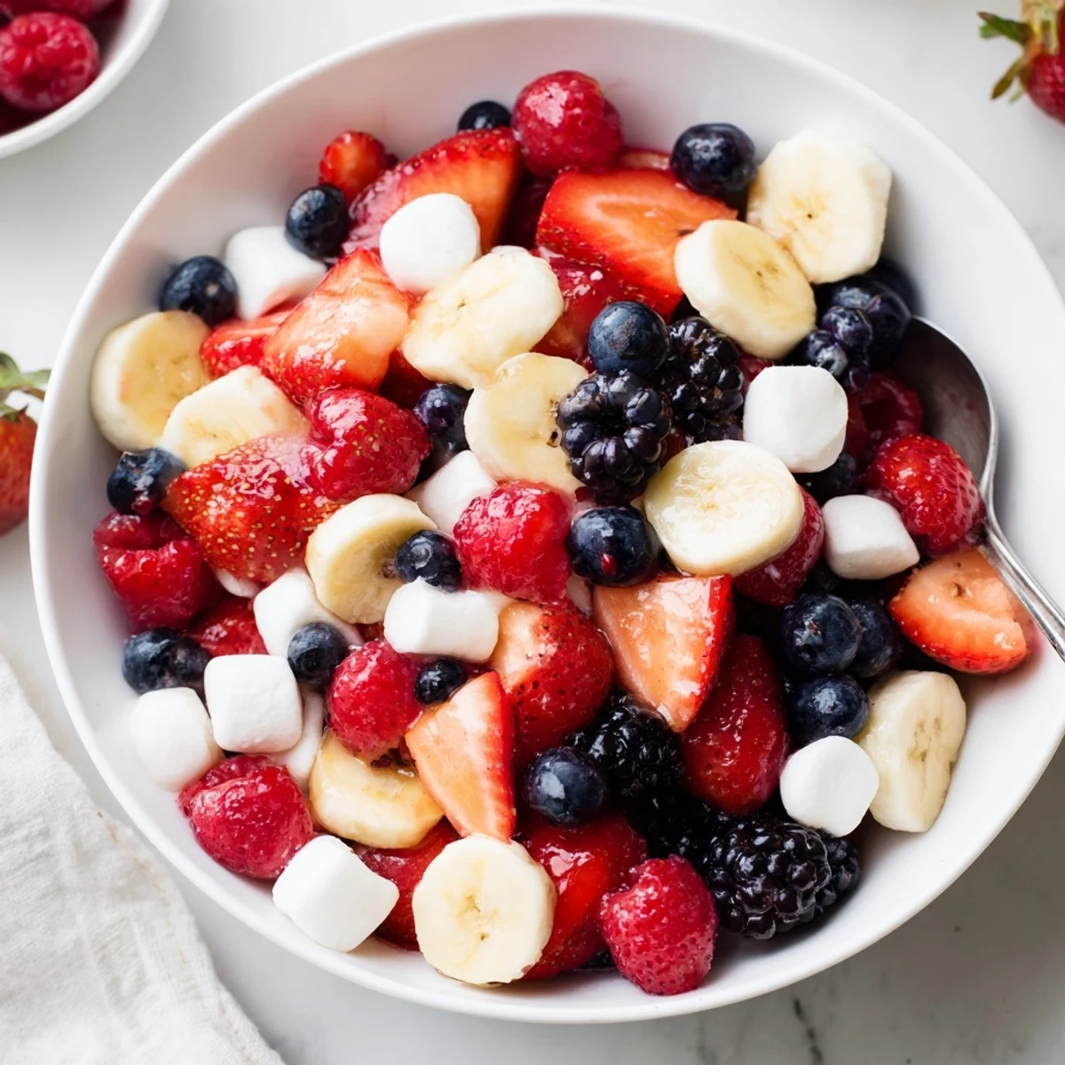 Tossed Red White And Blue Fruit Salad bright with citrus-honey dressing