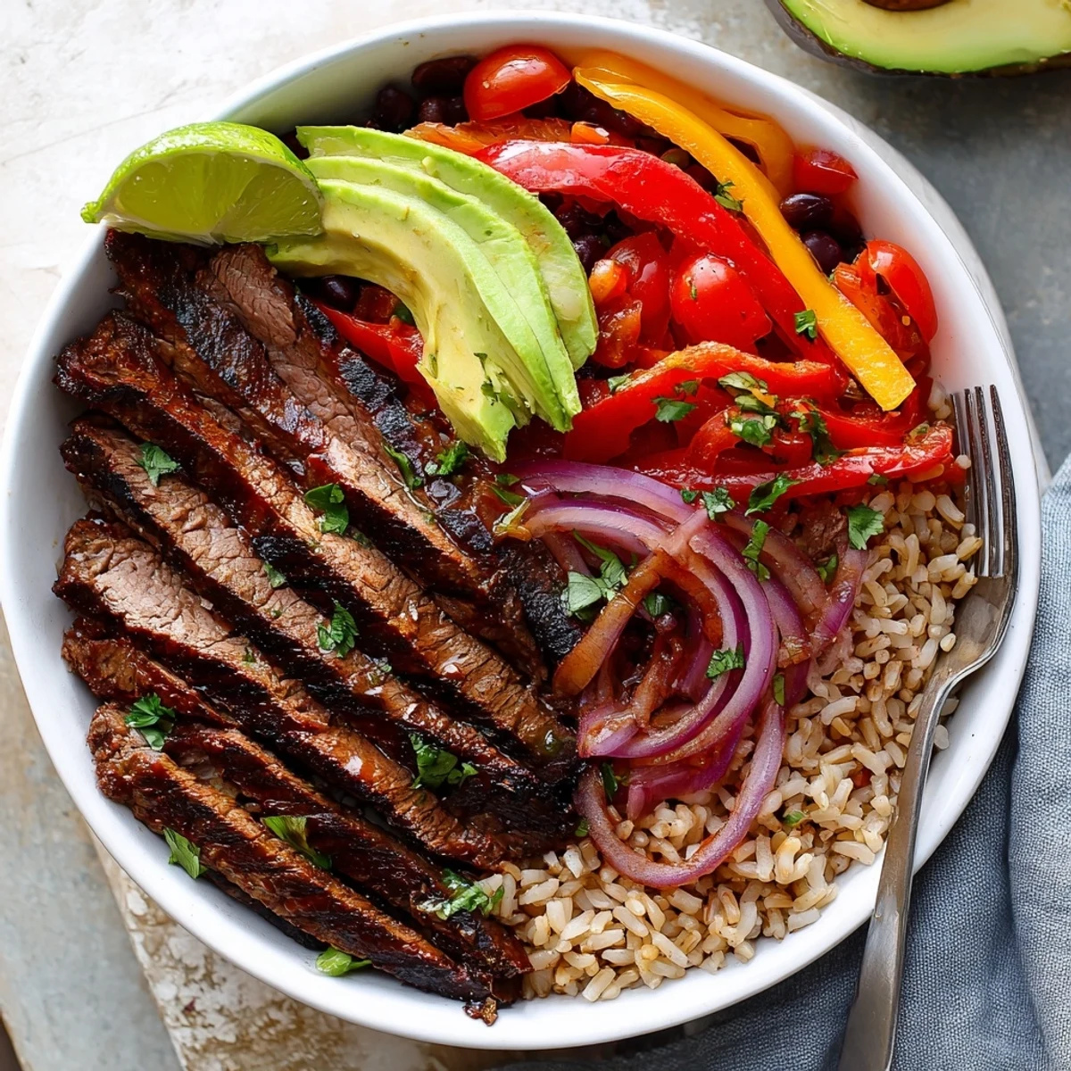 Steak Fajita Power Bowls with sizzling marinated steak, vibrant peppers and lime.