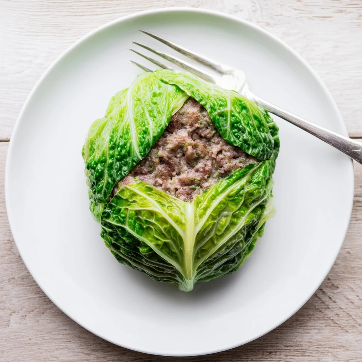 Juicy oven baked cabbage burger patty seasoned and encased in blanched cabbage leaves