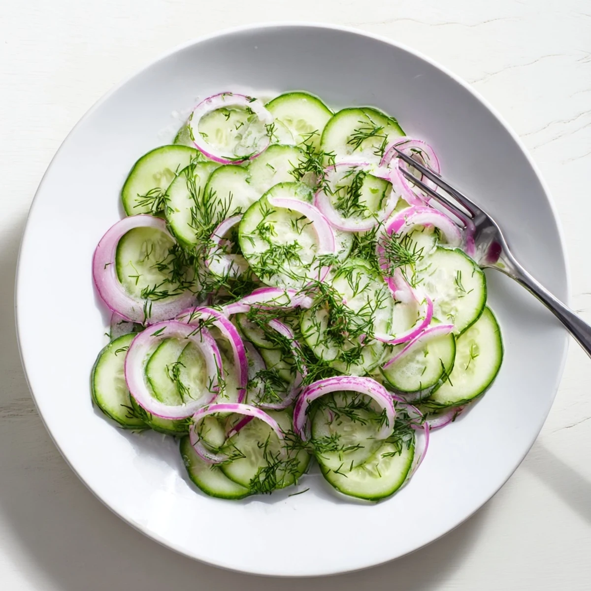 Crisp cucumber salad with thinly sliced red onions drizzled with sweet and tangy vinaigrette