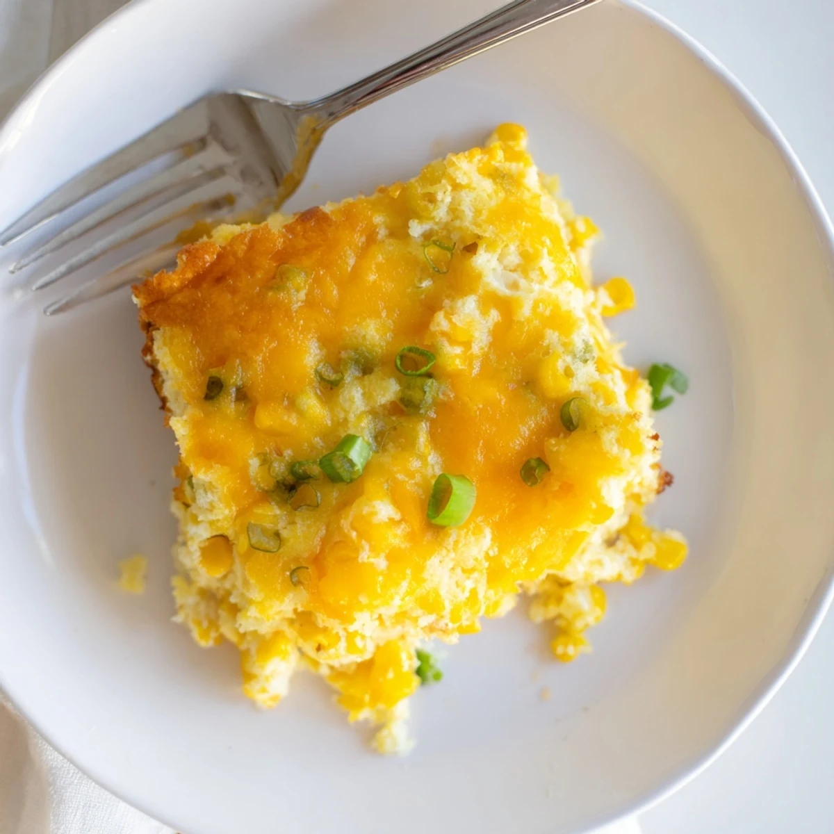 Golden brown Jiffy corn casserole with creamy corn kernels bubbling under a crispy top layer