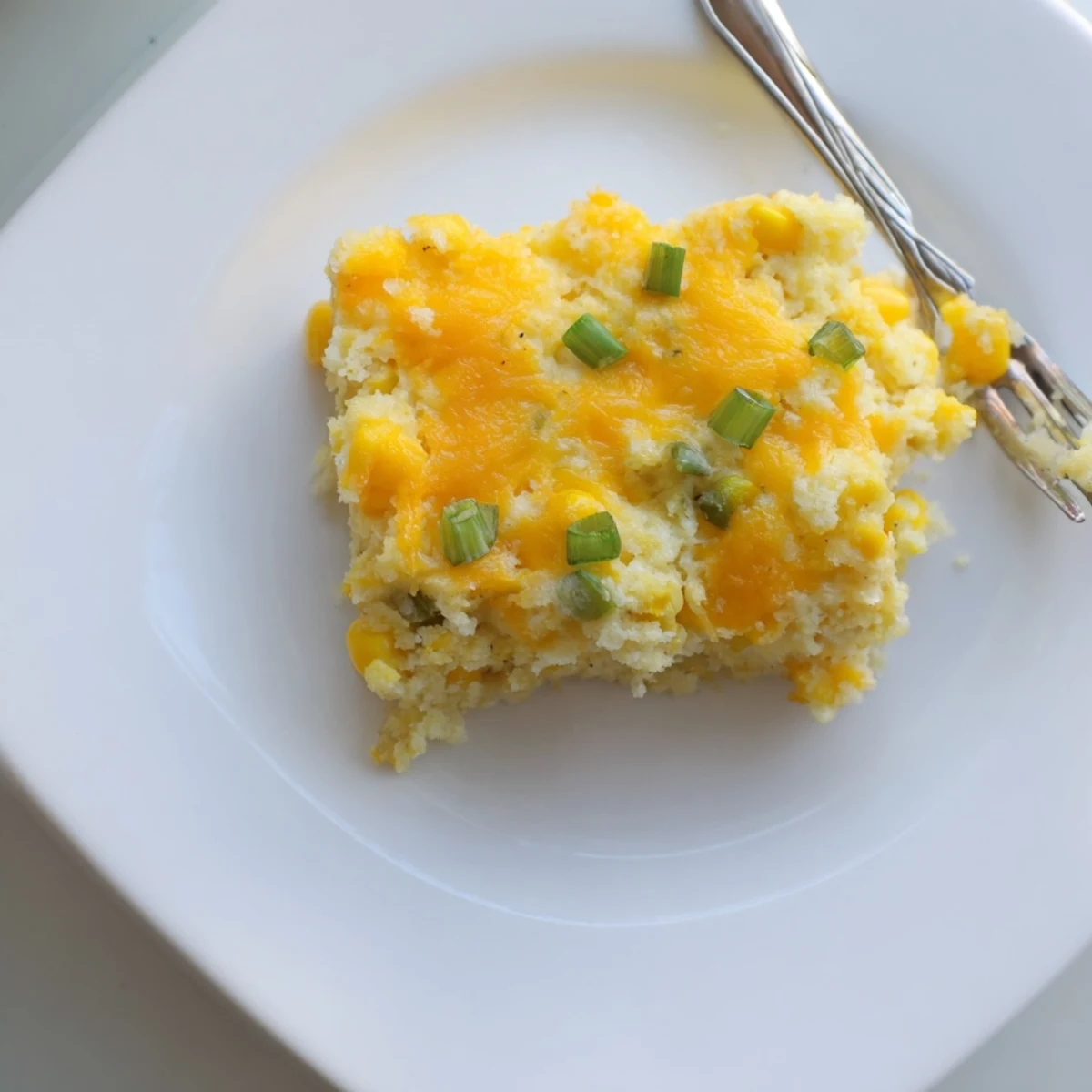 Creamy homemade Jiffy corn casserole fresh from the oven with melted butter glistening on top
