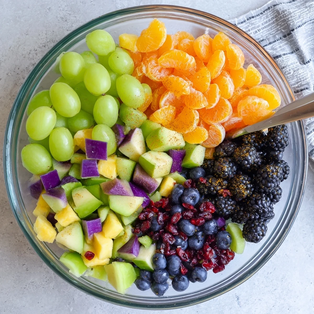 Spooky themed fruit salad bowl drizzled with tangy honey orange dressing and fresh seasonal fruits