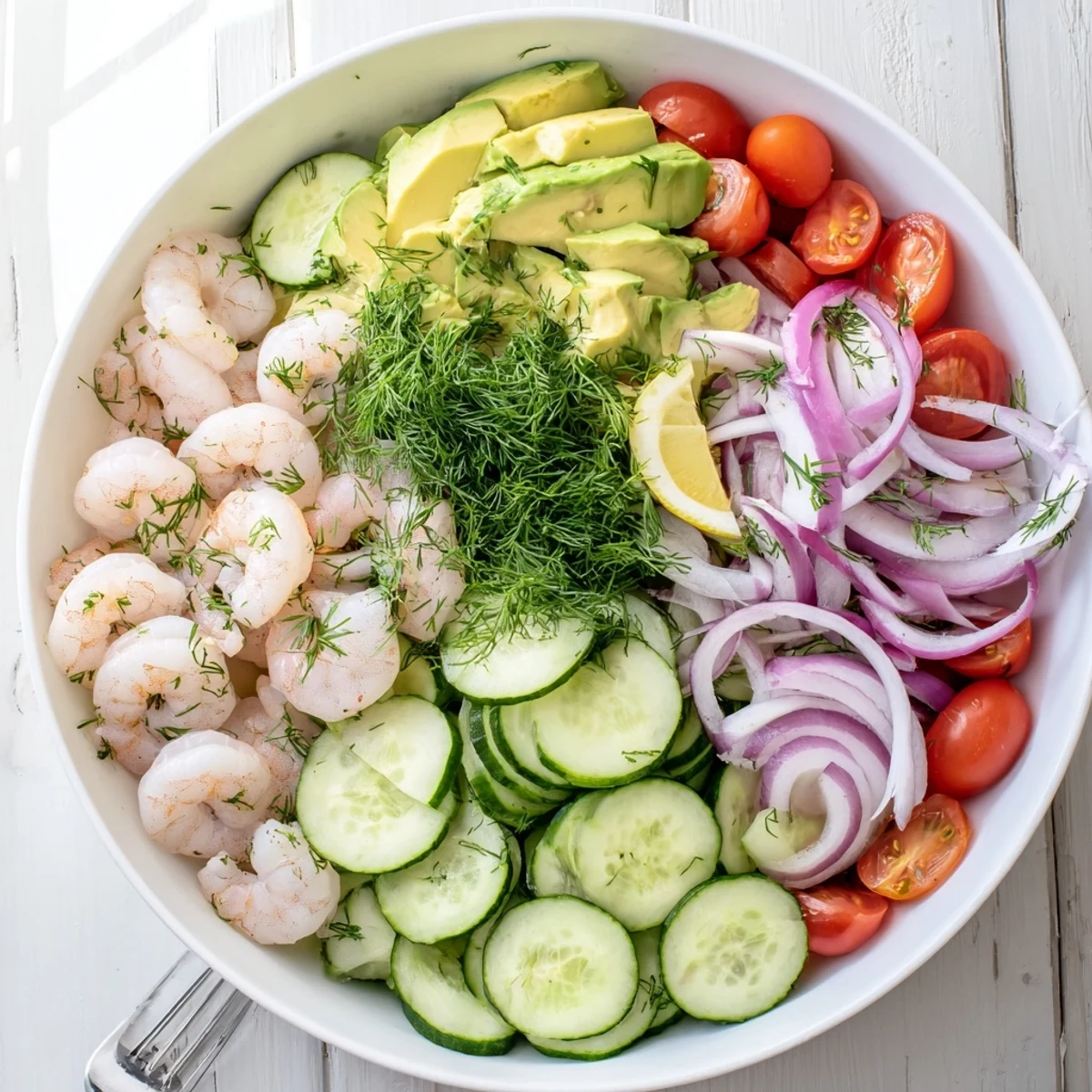 Light and refreshing cucumber shrimp salad topped with dill and lemon wedges