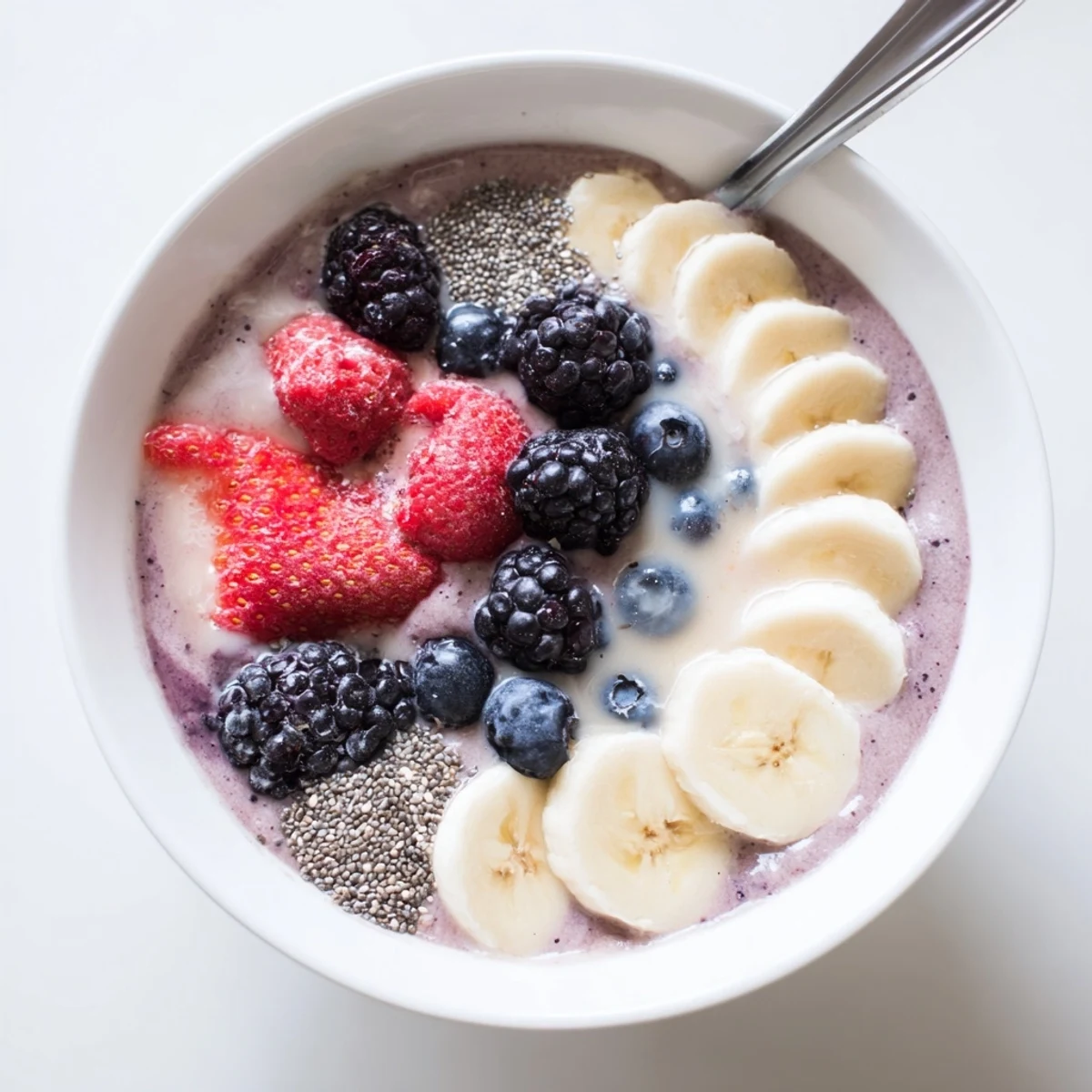 Vibrant Summer Berry Smoothie poured over ice, sprinkled chia seeds