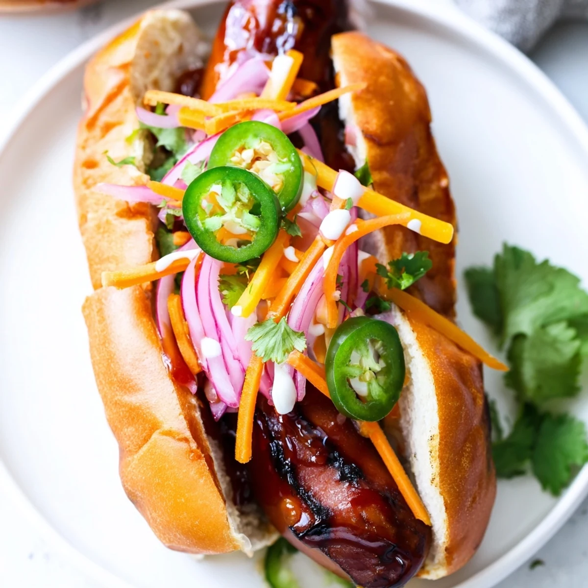 Spicy Firecracker Hot Dogs recipe showcasing caramelized grilled hot dogs with crunchy julienned toppings and drizzled mayonnaise in split buns