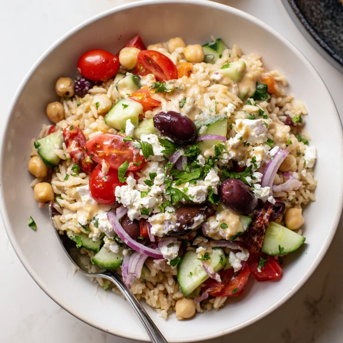 Fluffy Mediterranean Rice Bowl drizzled with tangy lemon-tahini dressing and fresh parsley