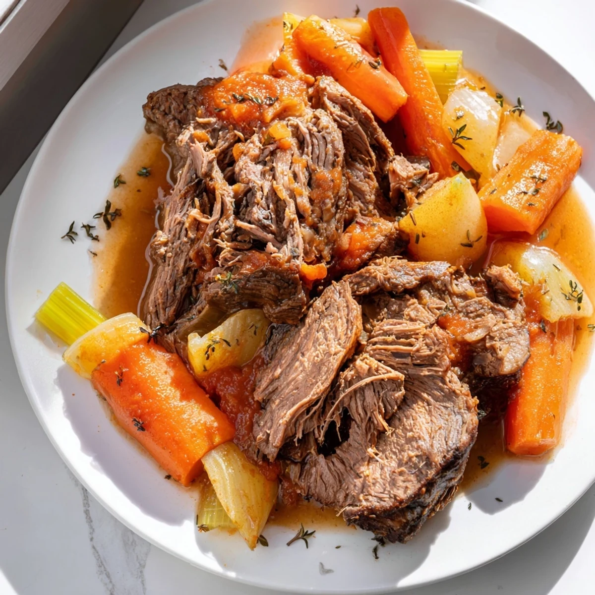 Perfect pot roast surrounded by tender carrots and onions in rich brown gravy