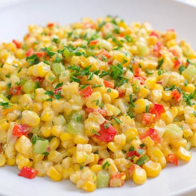 This easy Creole Corn Maque Choux with Peppers is a creamy Southern side dish garnished with fresh parsley and scallions.