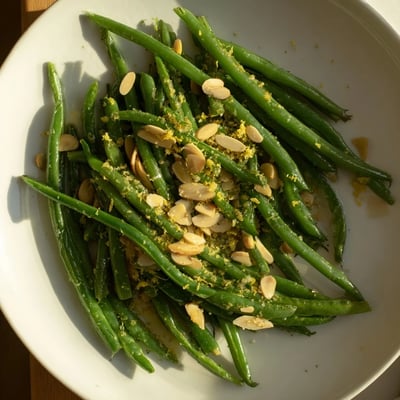 Vibrant, fresh Green Beans with Toasted Almonds and Lemon paired beside roasted chicken for a colorful weeknight side dish.  