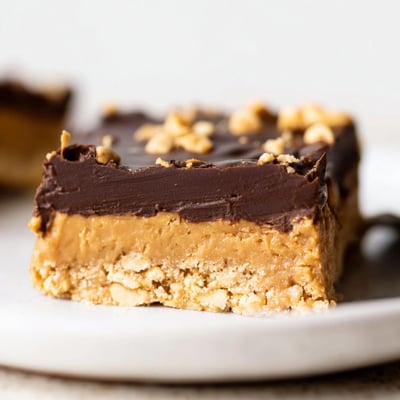 Thick Peanut Butter Bars with crumbly graham base, nutty aroma, sliced