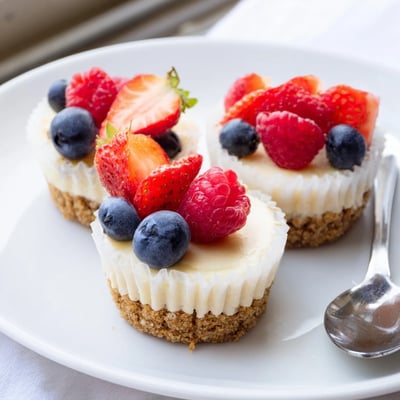 Golden graham crust mini cheesecakes drizzled with rich chocolate ganache sauce